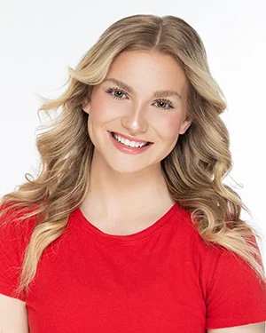 headshot blonde red top smiling